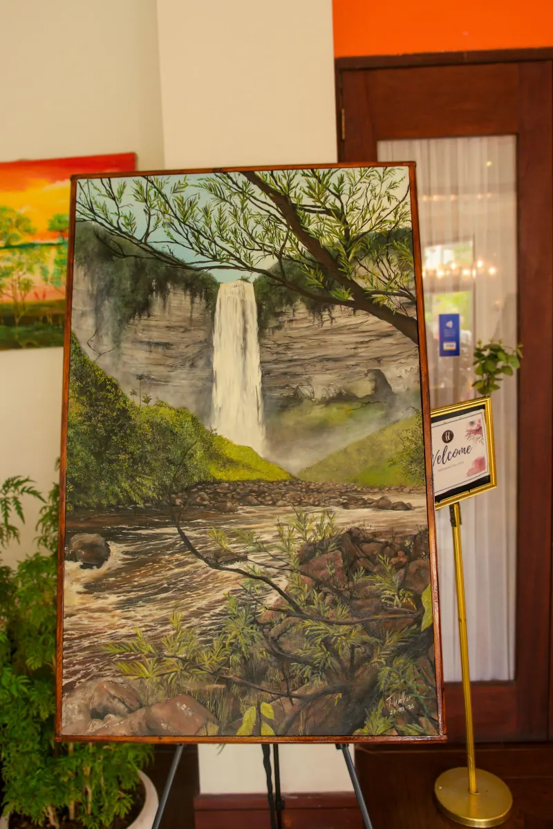 A painting of a tall waterfall falling into a forested gorge