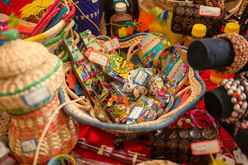 A basket of woven crafts and Guyana souvenirs