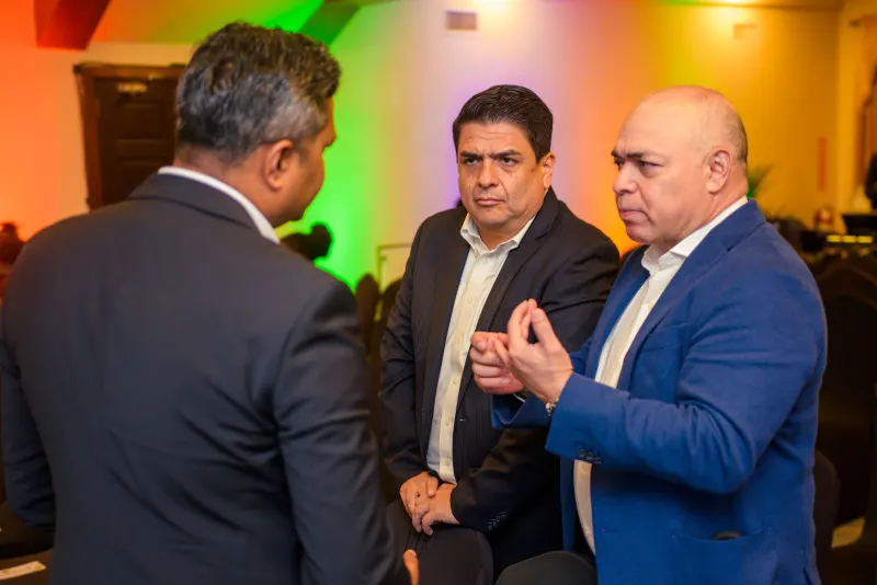 Three guests in conversation at the launch